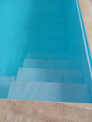 a group of blue steps in a swimming pool at Dida Joja in Lički Osik
