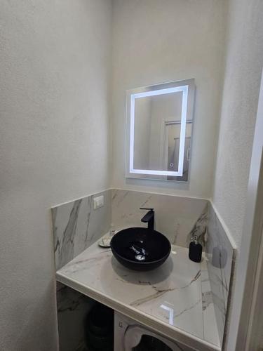 a bathroom with a black sink and a mirror at La Casa di Colombetta in Badalucco