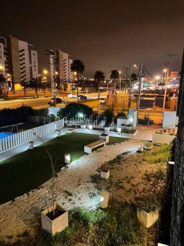 a park in a city at night with buildings at Herradura Vista II in Coquimbo