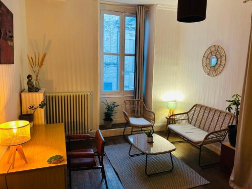 un salon avec un canapé, des chaises et une table dans l'établissement Chambre double au 1 er étage, à Saint-Maixent-lʼÉcole