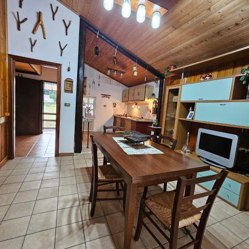 a dining room with a wooden table and chairs at Chalet del Lago Laceno in Villaggio Laceno