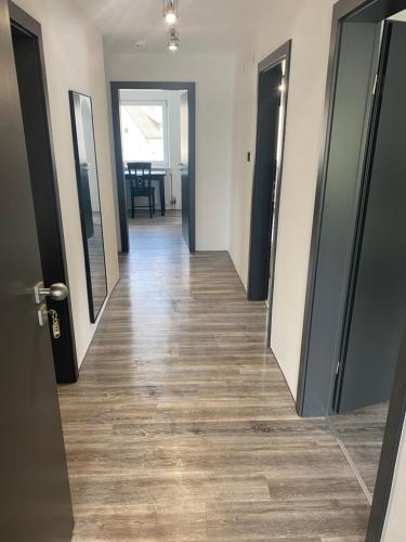 a hallway with doors and wooden floors in a building at Wohnung im Herzen von Vohenstrauß in Vohenstrauß