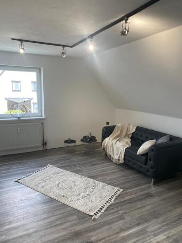 a living room with a couch and a rug at Wohnung im Herzen von Vohenstrauß in Vohenstrauß