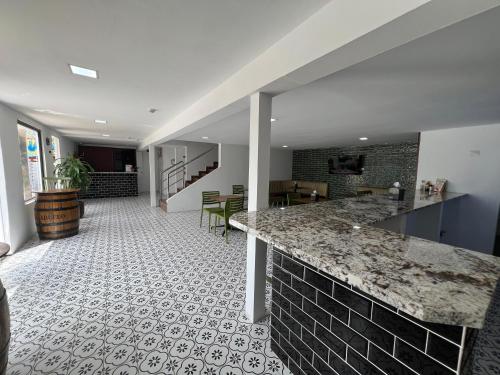 a kitchen with a counter and a tile floor at Express Inn PTY Aeropuerto Internacional Panama in Tocumen