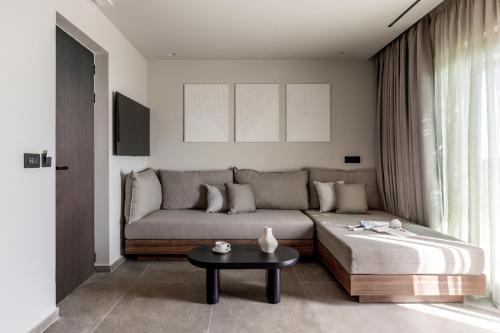 a living room with a couch and a table at Elios Hill in Hersonissos