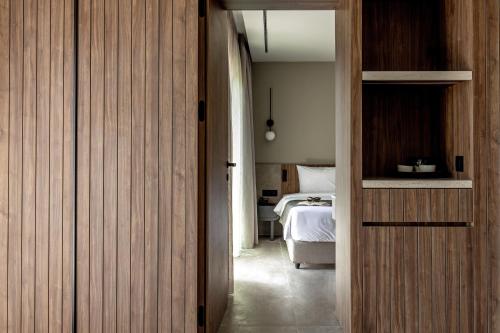 a room with a bedroom with a bed and a door at Elios Hill in Hersonissos