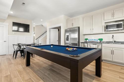 a living room with a pool table in a kitchen at Summer Salt 10 Bedroom Home at Hattie Creef Landing in Salvo
