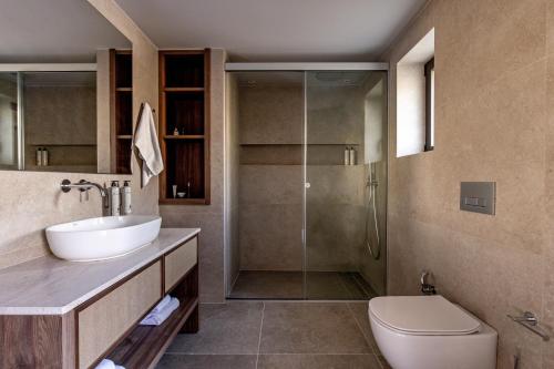 a bathroom with a toilet and a sink and a shower at Elios Hill in Hersonissos