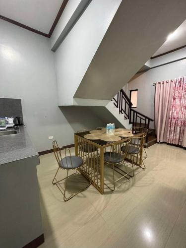 a dining room with a table and some chairs at JP Suites & Residences in Tayabas