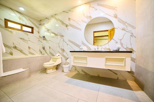 a bathroom with a sink and a mirror at El Rodeo Estancia Boutique Hotel & Steakhouse in San José
