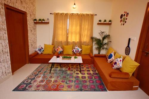 a living room with a couch and a table at ZoomStay - 3BHK Apartments in Varanasi