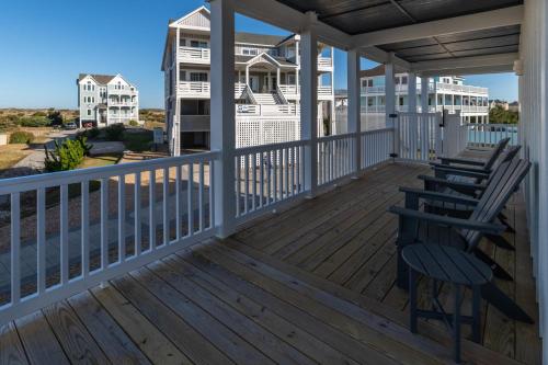 a porch with chairs and a view of the ocean at Summer Salt 10 Bedroom Home at Hattie Creef Landing in Salvo