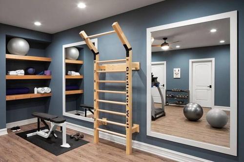 a room with a gym with a mirror and a treadmill at New Constructed Home in Poway in Poway