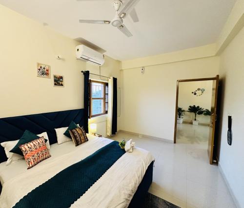 a bedroom with a large bed and a large mirror at ZoomStay - 3BHK Apartments in Varanasi
