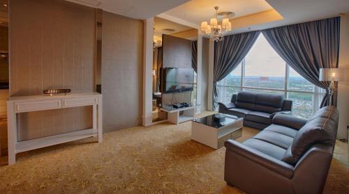a living room with a couch and a television at KSL Hotel & Resort in Johor Bahru