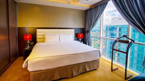 a bedroom with a large bed and a large window at KSL Hotel & Resort in Johor Bahru