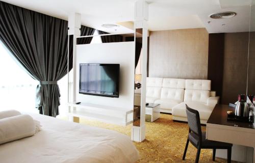 a hotel room with a bed and a tv and a desk at KSL Hotel & Resort in Johor Bahru