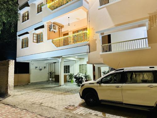 a white car parked in front of a building at ZoomStay - 3BHK Apartments in Varanasi