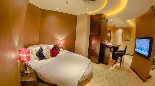 a hotel room with a bed and a television at KSL Hotel & Resort in Johor Bahru