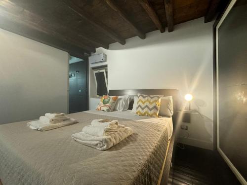 a bedroom with a bed with towels on it at In Ancient Rome Apartment in Rome