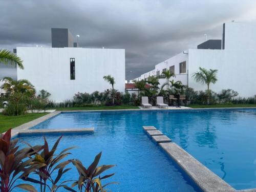 a swimming pool in front of a white building at Casa ensueño in Los Algodones