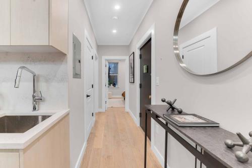 a kitchen with a sink and a mirror on the wall at Modern 3Bd Rose Hills Manhattan Terrace Space in New York