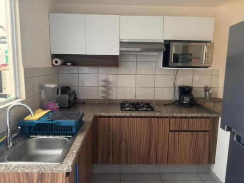 a kitchen with a sink and a counter top at Casa ensueño in Los Algodones