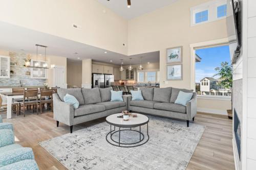 a living room with two couches and a table at Summer Salt 10 Bedroom Home at Hattie Creef Landing in Salvo