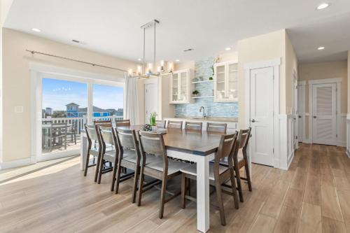 a kitchen and dining room with a table and chairs at Summer Salt 10 Bedroom Home at Hattie Creef Landing in Salvo