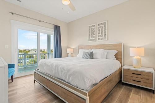 a bedroom with a large bed and a balcony at Summer Salt 10 Bedroom Home at Hattie Creef Landing in Salvo