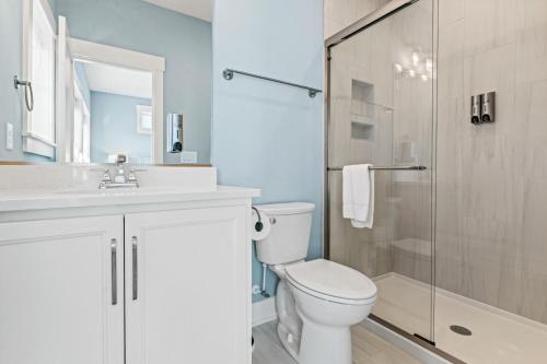 a bathroom with a toilet and a glass shower at Summer Salt 10 Bedroom Home at Hattie Creef Landing in Salvo