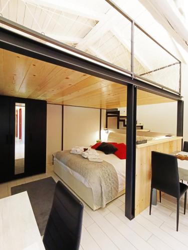 a bedroom with a large bed and a loft at CARLOTTA FIERA SUITE in Bologna