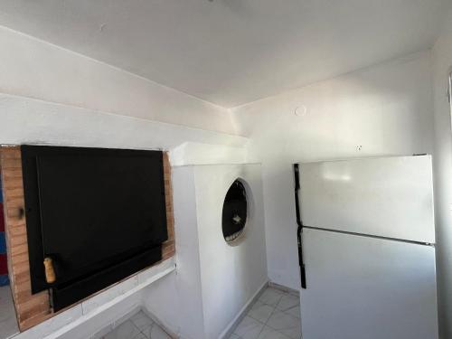 a small kitchen with a refrigerator and a window at Villa Garruchal in El Caracolero