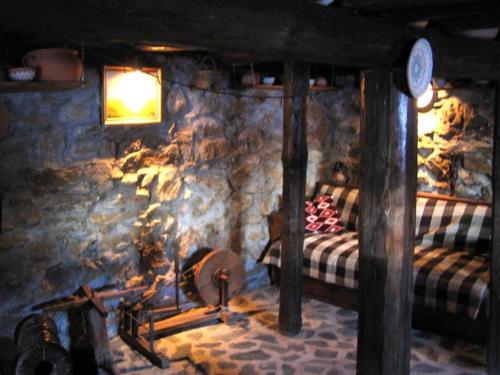 a room with a bed and a stone wall at Ski liviomoritz at gma il com Chalet in Madzhare