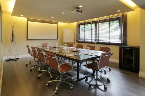 a conference room with a long table and chairs at The Y Hotel in Athens