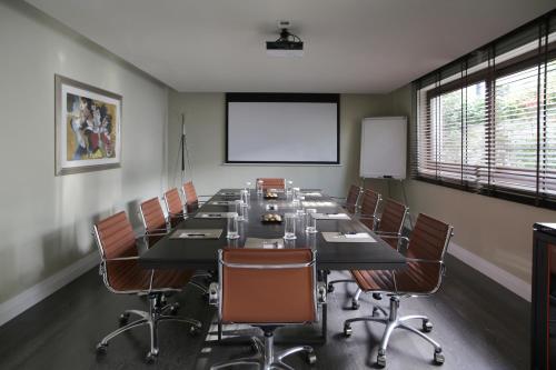 a conference room with a long table and chairs at The Y Hotel in Athens