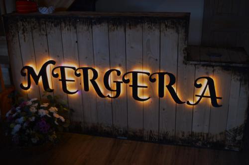 a sign that says mergency with lights on a fence at Hotel Mergera in Mērsrags