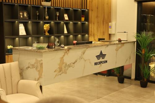 a lobby with a reception counter in a building at Hotel Luna in Prizren
