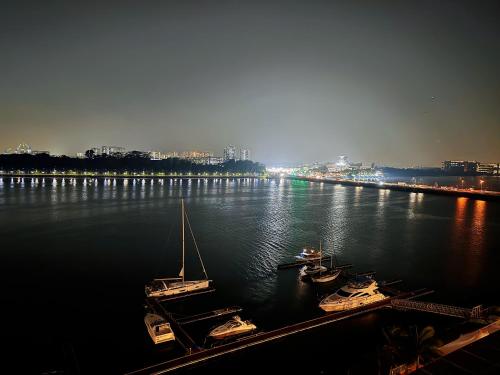 a group of boats docked in a river at night at TheBess Hotel Tokyo is located adjacent to Singapore and offers a sea viewIt is a family business smart room with the sea view of Princess Bay富力公主湾 in Johor Bahru