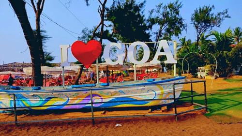 a boat with a heart sign and a sign that says i love at 2 BHK luxury apartment in Calangute beach Saldana in Calangute