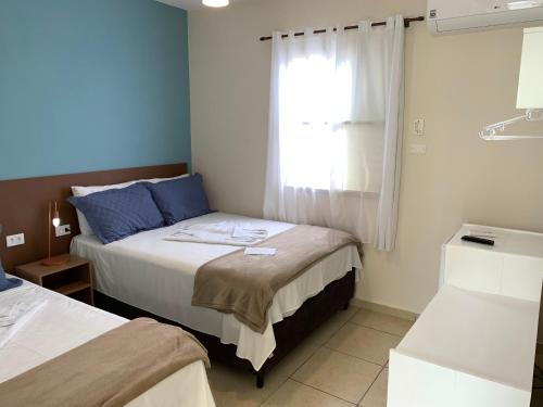 Ένα ή περισσότερα κρεβάτια σε δωμάτιο στο Pousada Moça Bonita