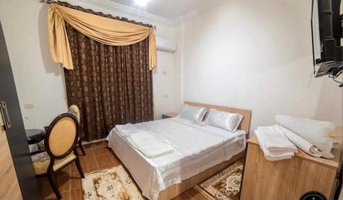 a small bedroom with a bed and a window at Al Borj Hotel فندق البرج 