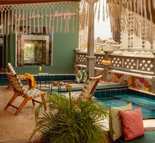 a living room with two chairs and a pool at Townhouse Boutique Hotel in Cartagena de Indias