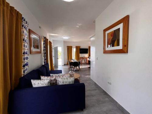 a living room with a blue couch and a table at Apartamento Carey in Cabrera