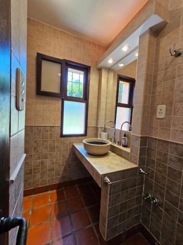 a bathroom with a bowl sink and a shower at Villa Arbolada in San Lorenzo