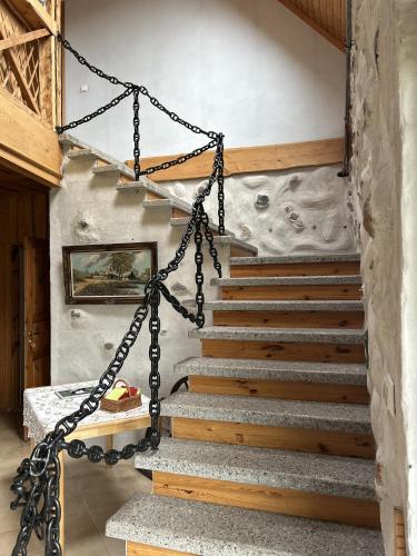 a staircase in a house with chains around it at Oraveski talu in Lodja