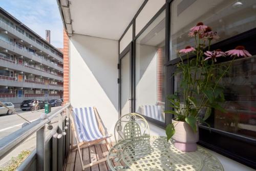 balcón con mesa, sillas y maceta en Luxury - Family friendly - Central - Cozy- Balcony, en Copenhague