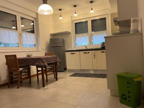 a kitchen with a table and chairs and a refrigerator at CasaNobile - Suite Il Grano in Merate