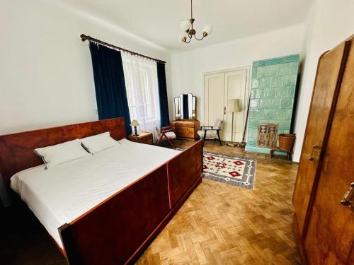 a bedroom with a large bed and a living room at Spacious Garden Villa in Lublin