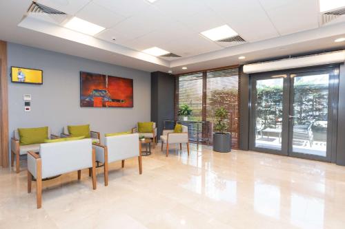 a waiting room with chairs and tables in a building at Park Inn by Radisson Istanbul Atasehir in Istanbul